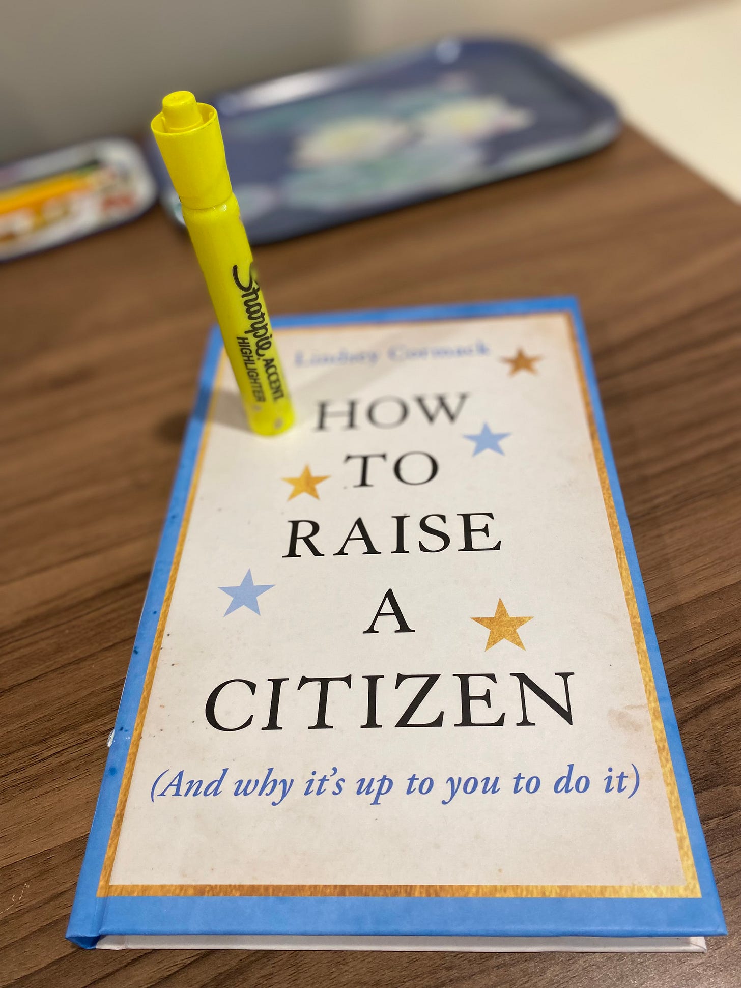 Picture of book on table with highlighter pen