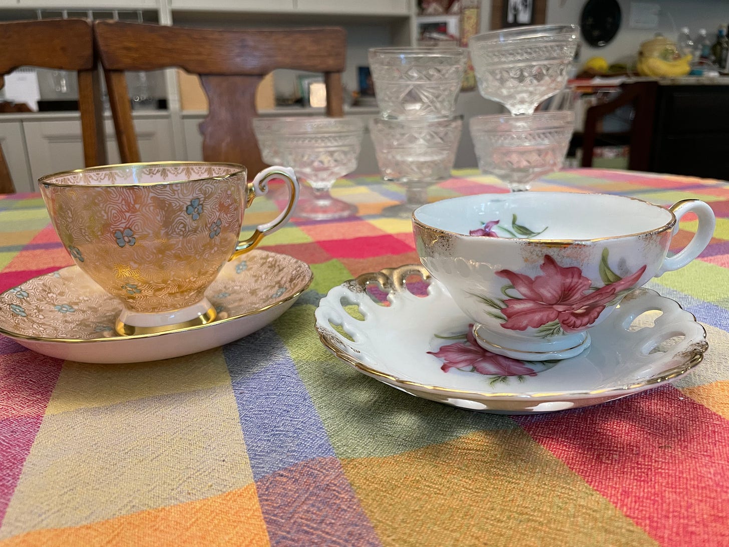 Two tea cups on a bright tablecloth