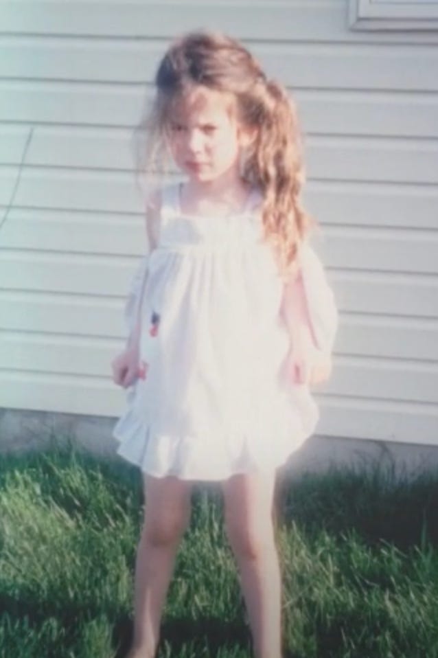 Cait as a little girl looking grumpy