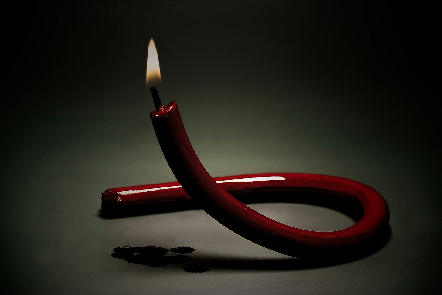 Red candle in the shape of an AIDS ribbon