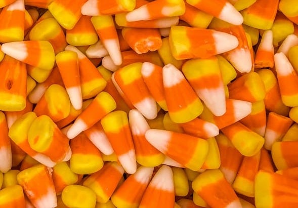 a pile of orange and white candy corn