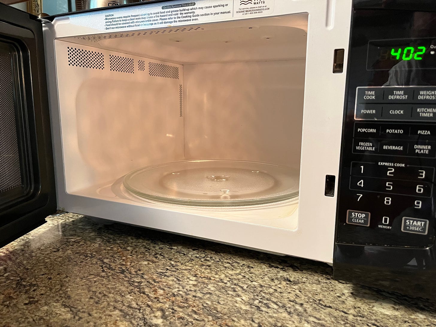A microwave with a glass door

Description automatically generated
