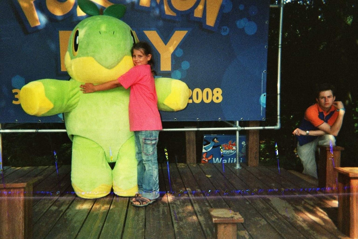 Kimberley hugs a Turtwig mascot on the stage, in 2008