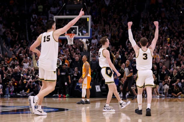 Zach Edey, Fletcher Loyer and Braden Smith of the Purdue Boilermakers celebrate after defeating the Tennessee Volunteers in the Elite 8 round of the...