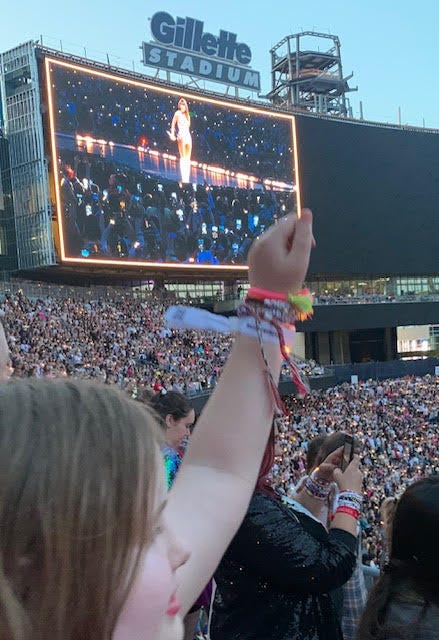 little girl holding up fist at Taylor Swift show