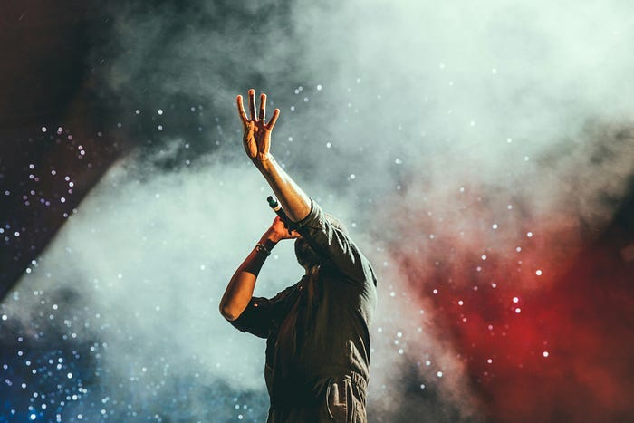 Man singing with mic in hand.