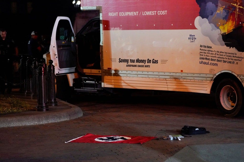 A Nazi flag and other objects recovered from a rented box truck are pictured on the ground as the U.S. Secret Service and other law enforcement agencies investigate the truck that crashed into security barriers at Lafayette Park across from the White House in Washington, U.S. May 23, 2023. 
