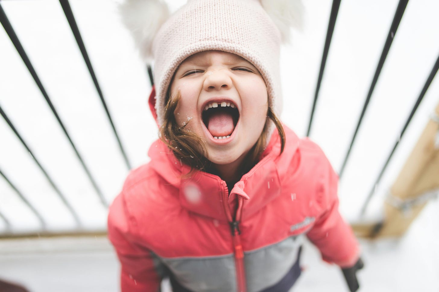 Young girl white hat red jacket screaming tantrum
