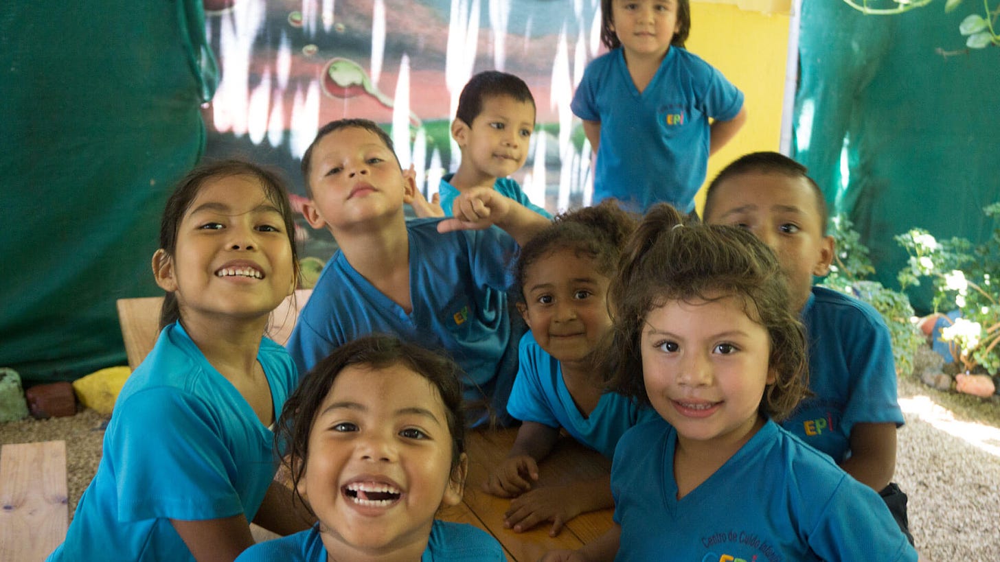 A group of children in blue shirts

Description automatically generated