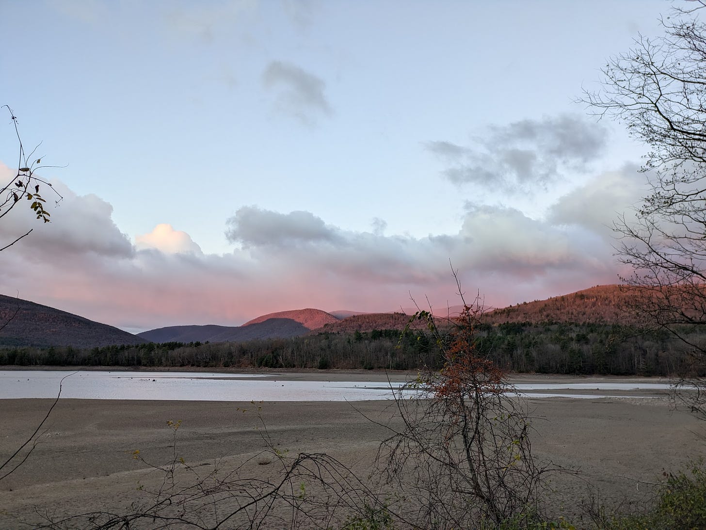 View of Catskill mountains, clouds, water and sand