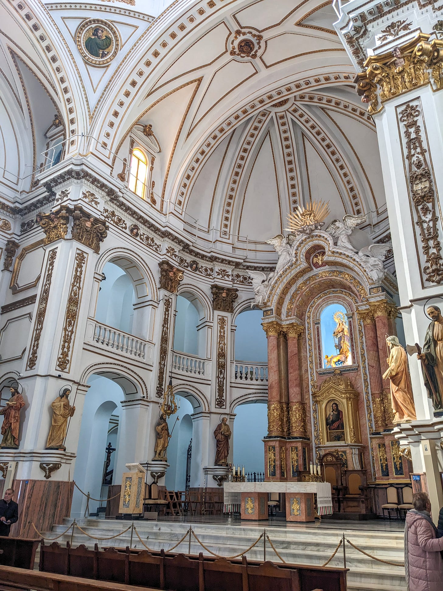 view of the interior of the Our Lady of Consolation Church, with white and gold colors.