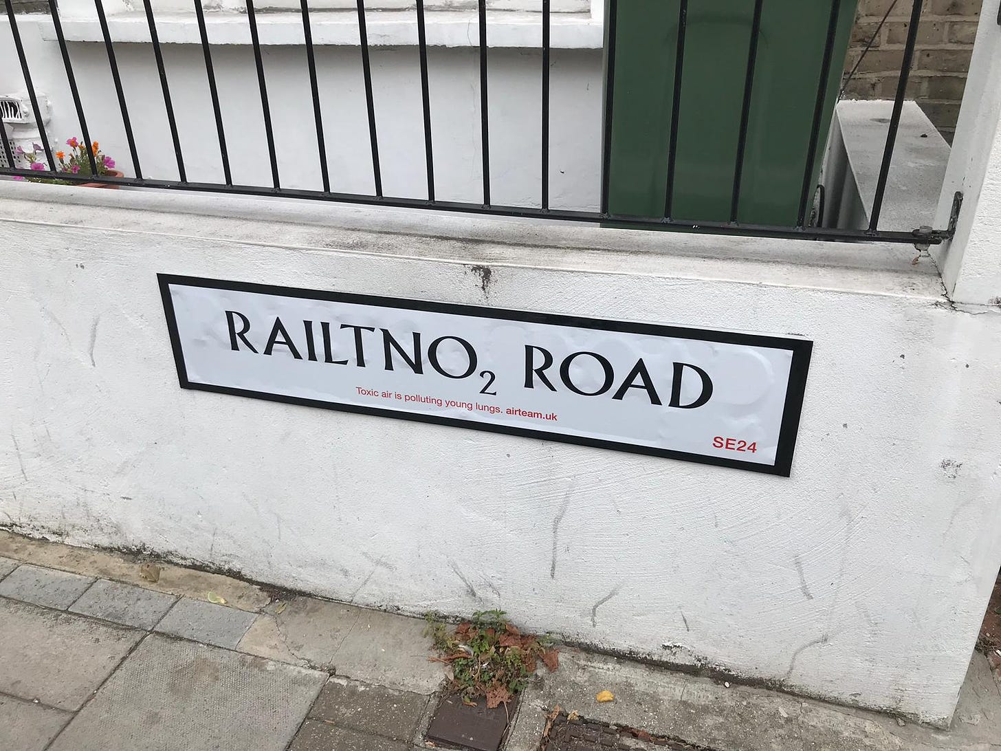 A photo of the Railton Road street sign that had been modified to read RailtNO2 Road