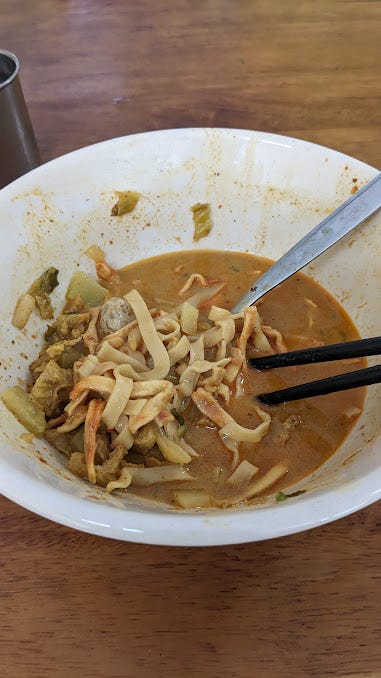 finising a bowl of khao soi