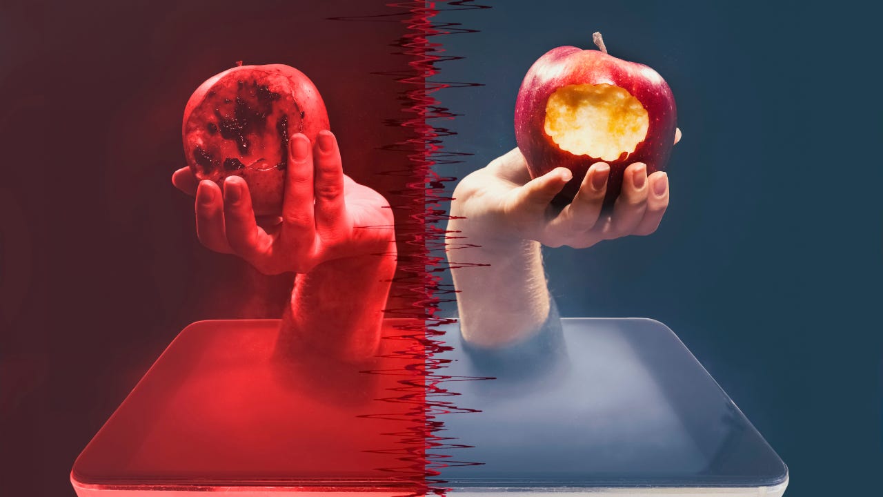 Two apples being held up. 