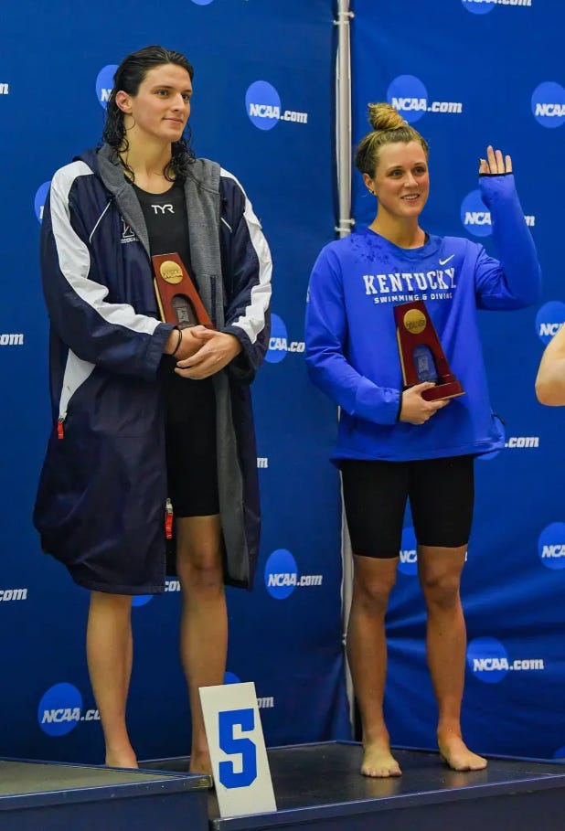 Riley Gaines and Lia Thomas standing side by side on the award podium at the NCAA competition.