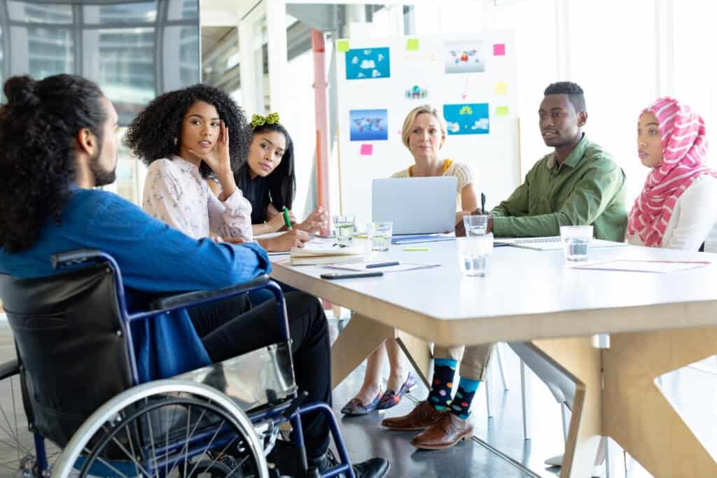 People discussing with each other in meeting at conference room in a modern office