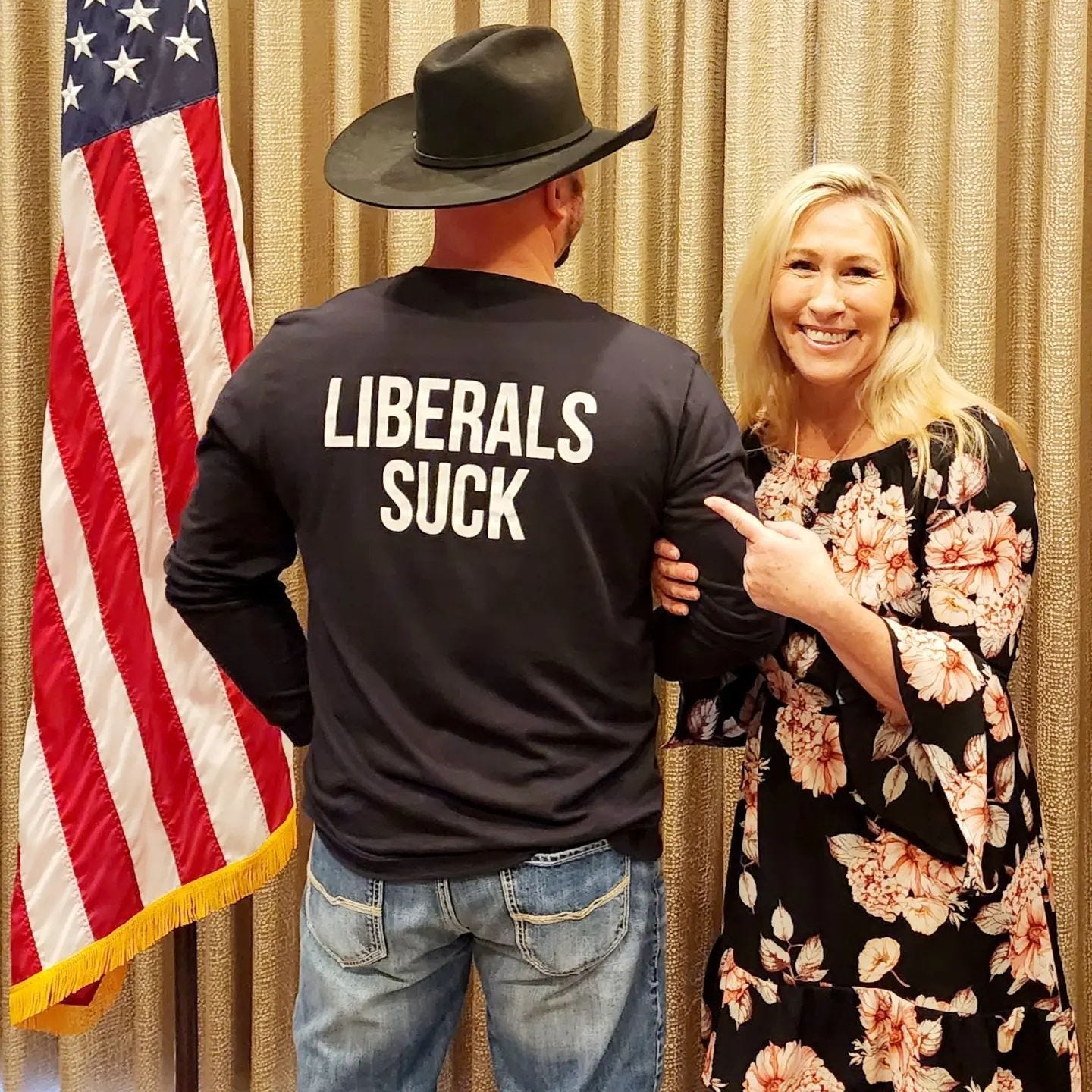 May be an image of 2 people, people standing and text that says 'LIBERALS SUCK បO'