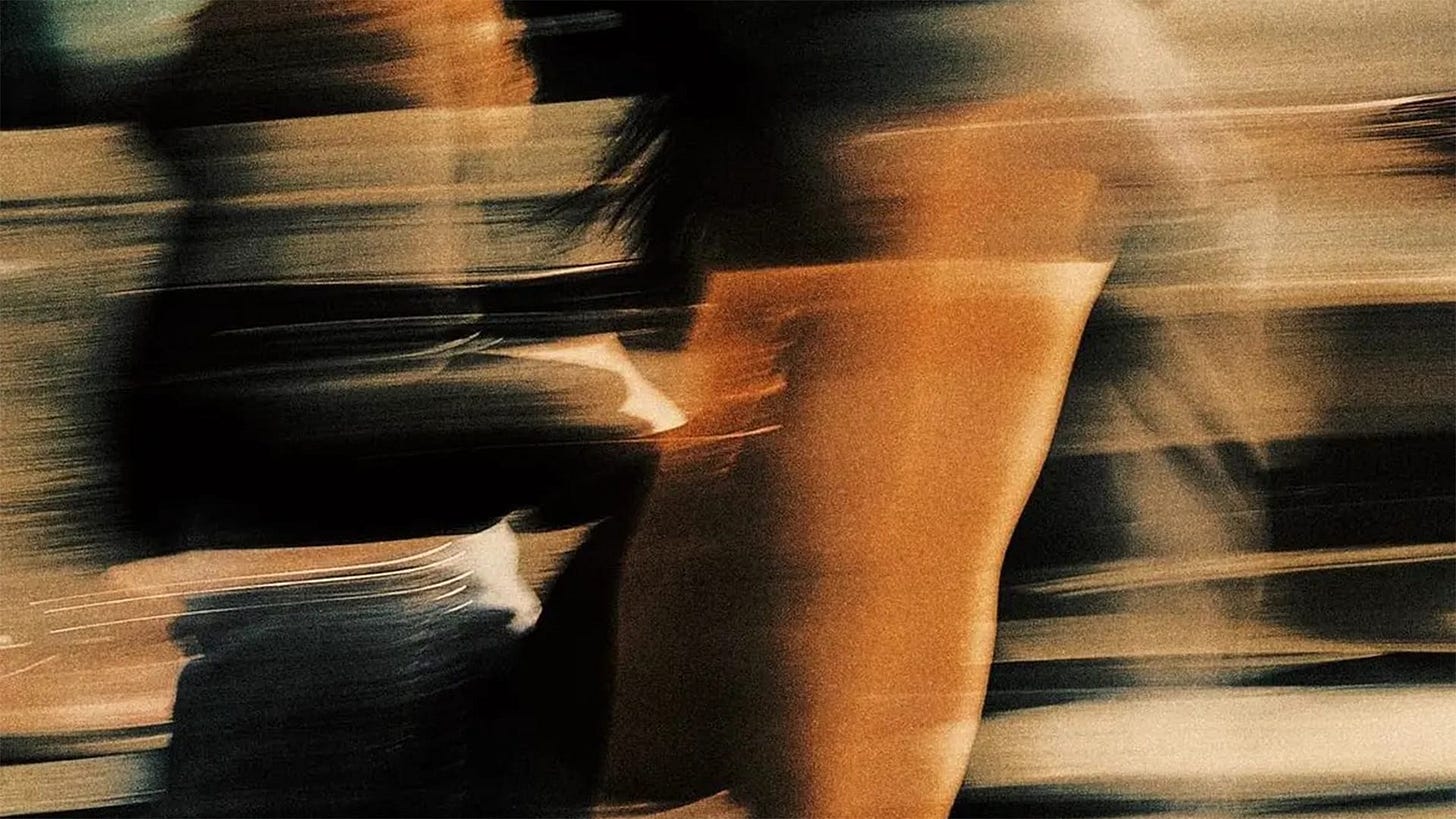 Two people walking. A heavy motion blur is applied to the photo. Two people walking. A heavy motion blur is applied to the photo.