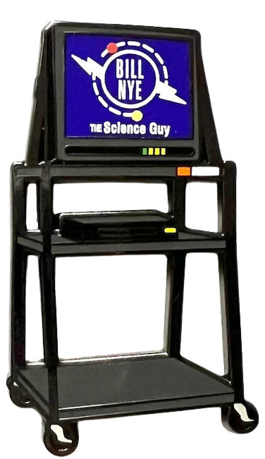 An enamel pin design. "Bill Nye the Science Guy" plays on an old TV that sits on top of a tall, wheeled cart that teachers would roll into your classroom in the '90s when you got to watch a VHS tape.