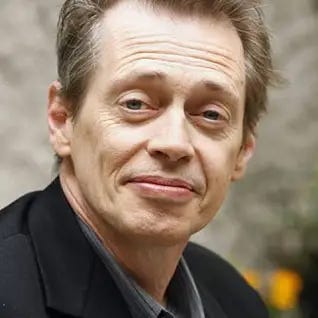 Photo of Steve Buscemi, a white actor probably in his 60s in this photo? with graying hair and looking incredible