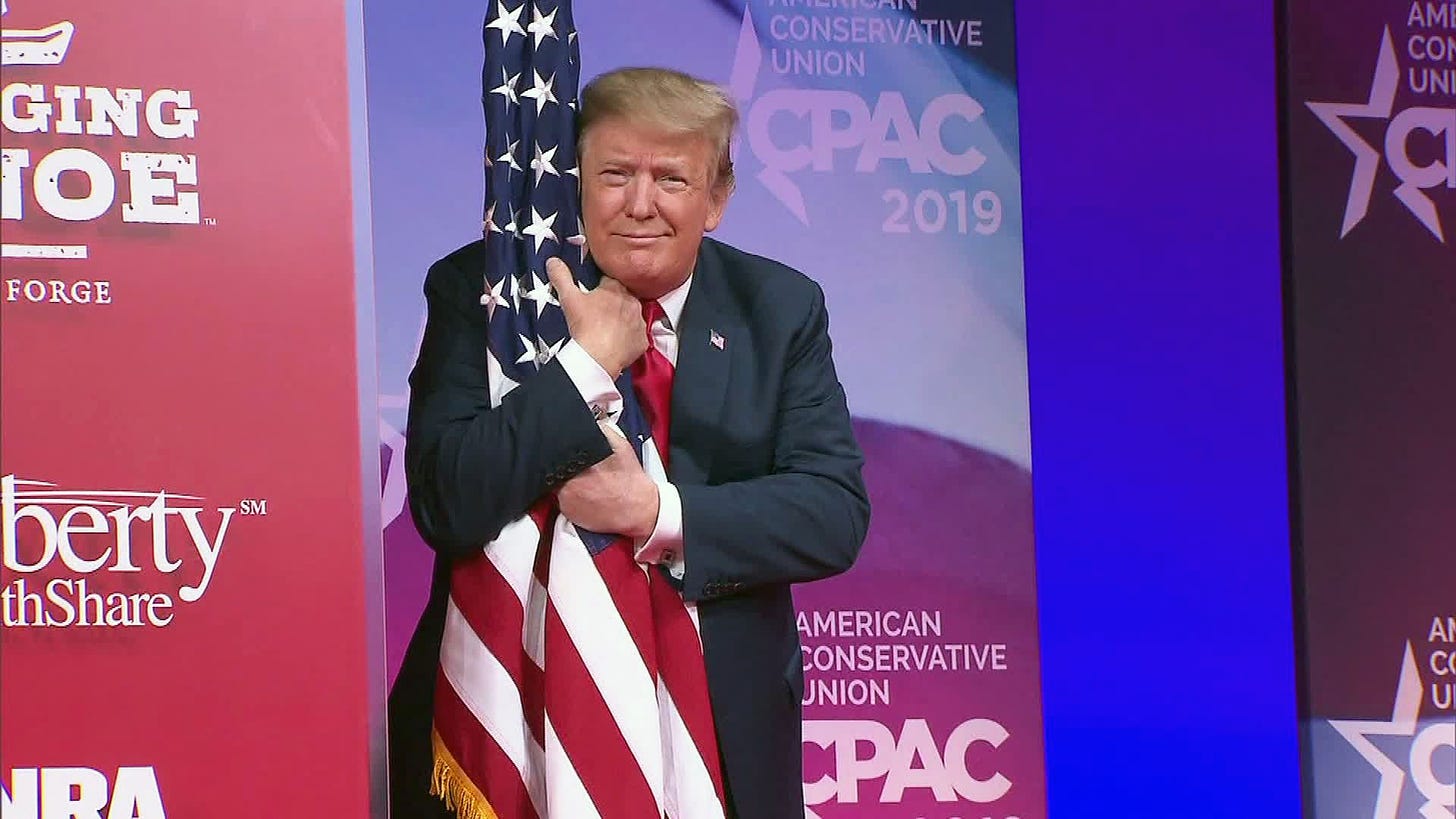 President Trump bear hugs Old Glory