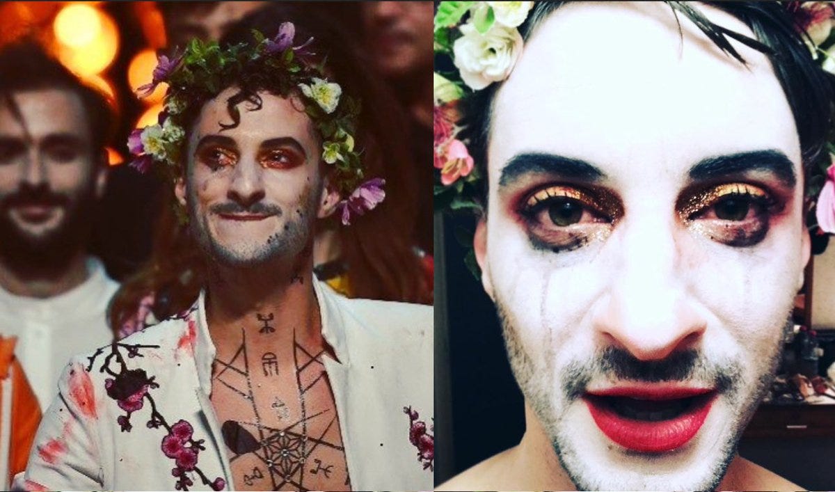 A person with flowers on his face and a person with a flower crown

Description automatically generated