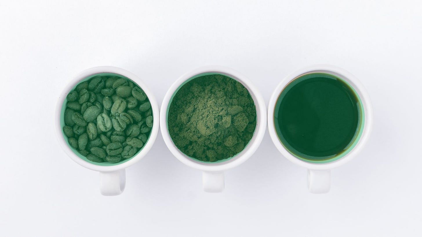Three cups of coffee, seen from above and overlaid with a green tinge. Left: coffee beans; middle, ground coffee; right, brewed coffee. 