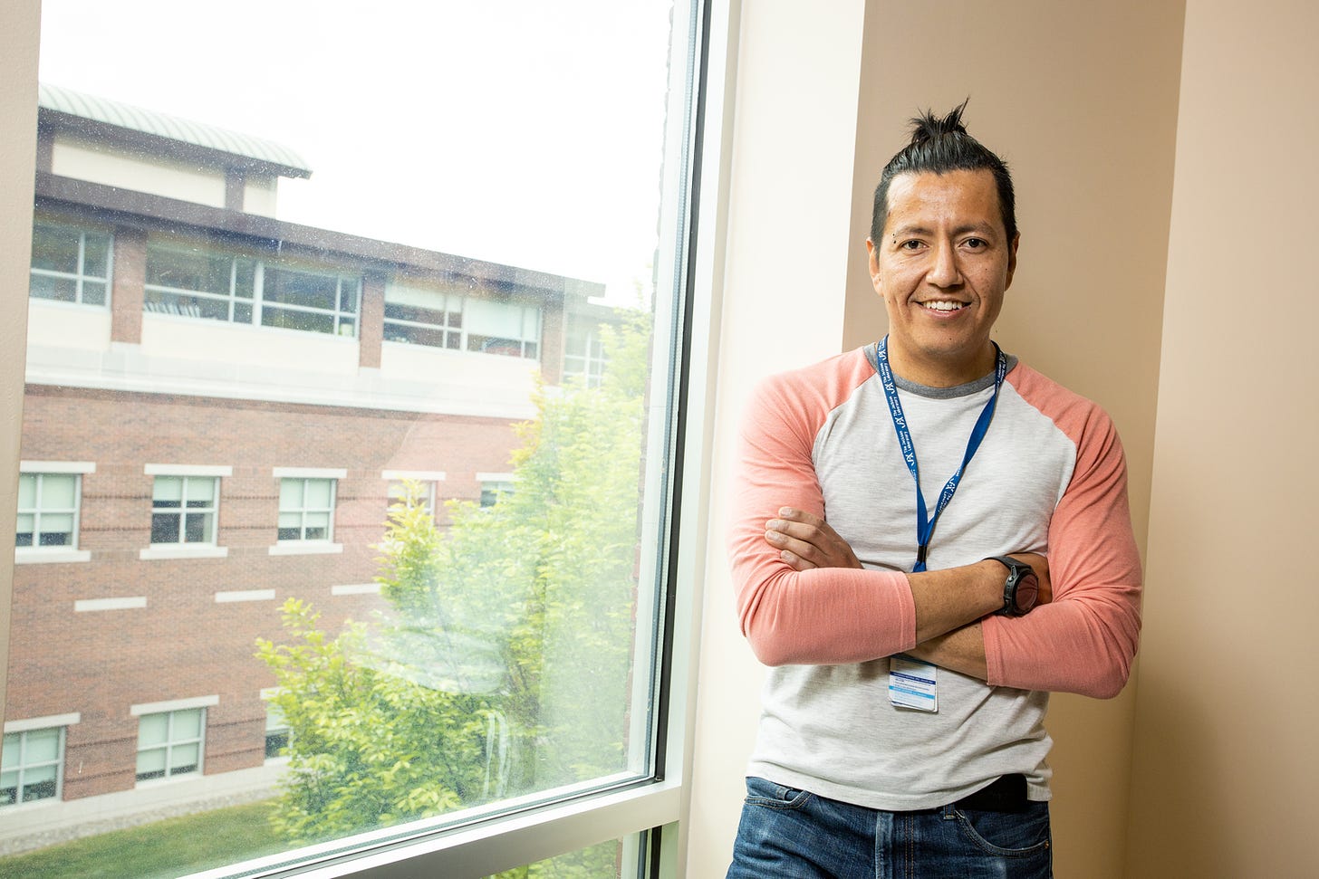 Dan Cortes pictured beside a window on the JAX campus