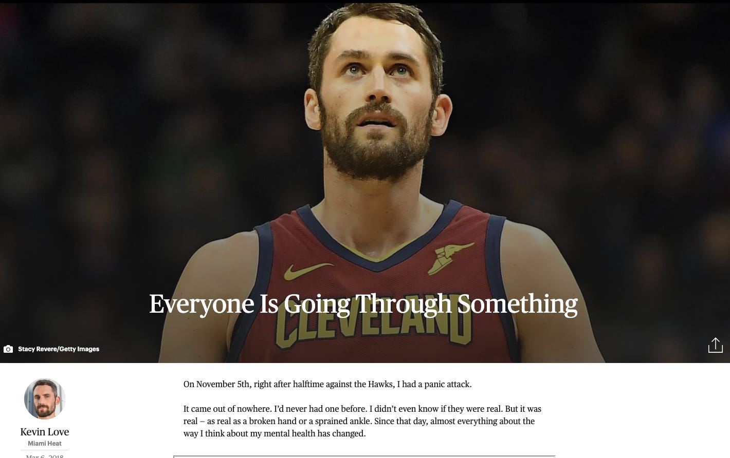 Kevin Love wearing a red Cleveland Cavaliers basketball jersey with blue trim and yellow letters saying Cleveland. Love is white with a brown beard. 