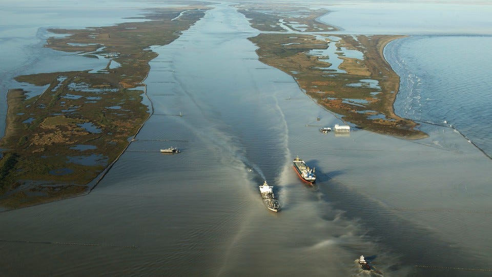 Two large boats travel on a drought-stricken Mississippi River