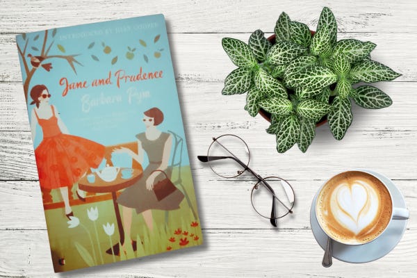 Table top containing book, green houseplant, cup of coffee and eye glasses