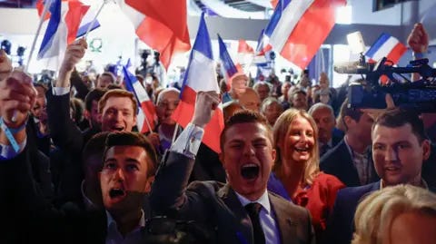 Reuters Young people dressed smartly wave French flags and cheer