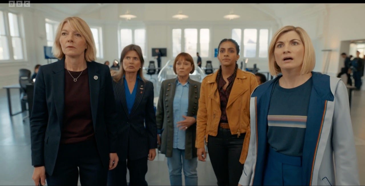 This image shows, from left to right, Kate Lethbridge-Stewart (played by Jemma Redgrave), Ace Gale (played by Sophie Aldred), Tegan Jovanka (played by Janet Fielding), Yasmin "Yaz" Khan (played by Mandip Gill), and the Thirteenth Doctor (played by Jodie Whittaker) standing inside UNIT Headquarters in Doctor Who Series 13's ninth episode, "The Power of the Doctor." This image shows, from left to right, Kate Lethbridge-Stewart (played by Jemma Redgrave), Ace Gale (played by Sophie Aldred), Tegan Jovanka (played by Janet Fielding), Yasmin "Yaz" Khan (played by Mandip Gill), and the Thirteenth Doctor (played by Jodie Whittaker) standing inside UNIT Headquarters in Doctor Who Series 13's ninth episode, "The Power of the Doctor."