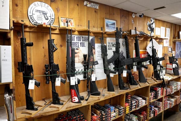 Guns line a wall of a gun store in Tinley Park, Ill.