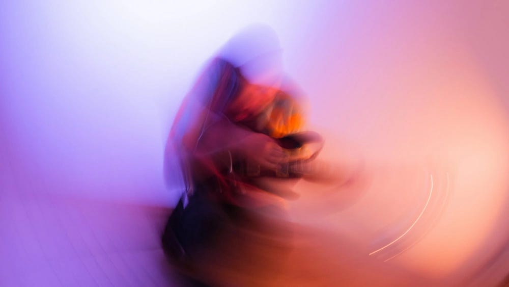 A blurry image of someone playing a guitar