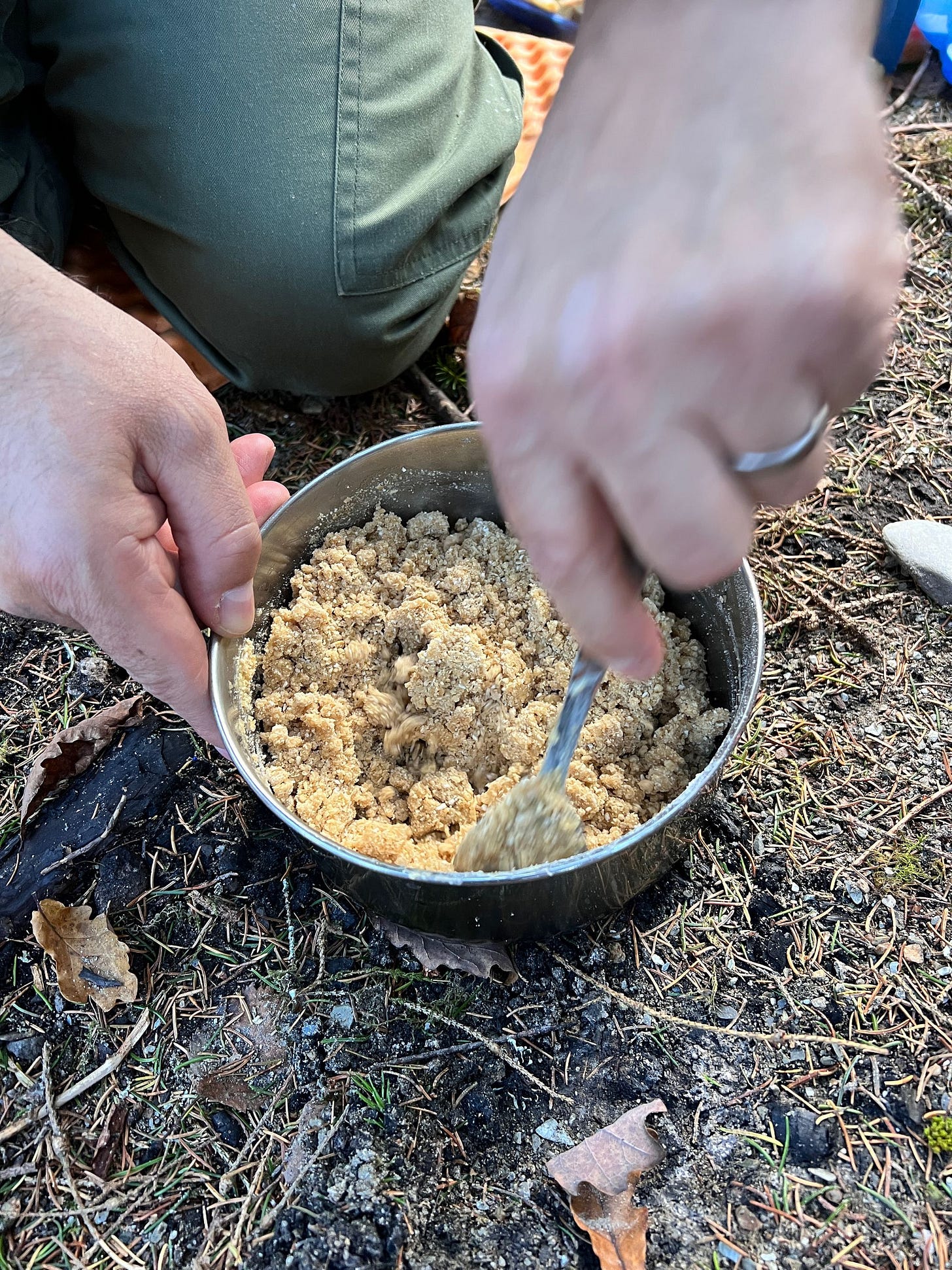 Me mixing the crumble mixture into the melted butter