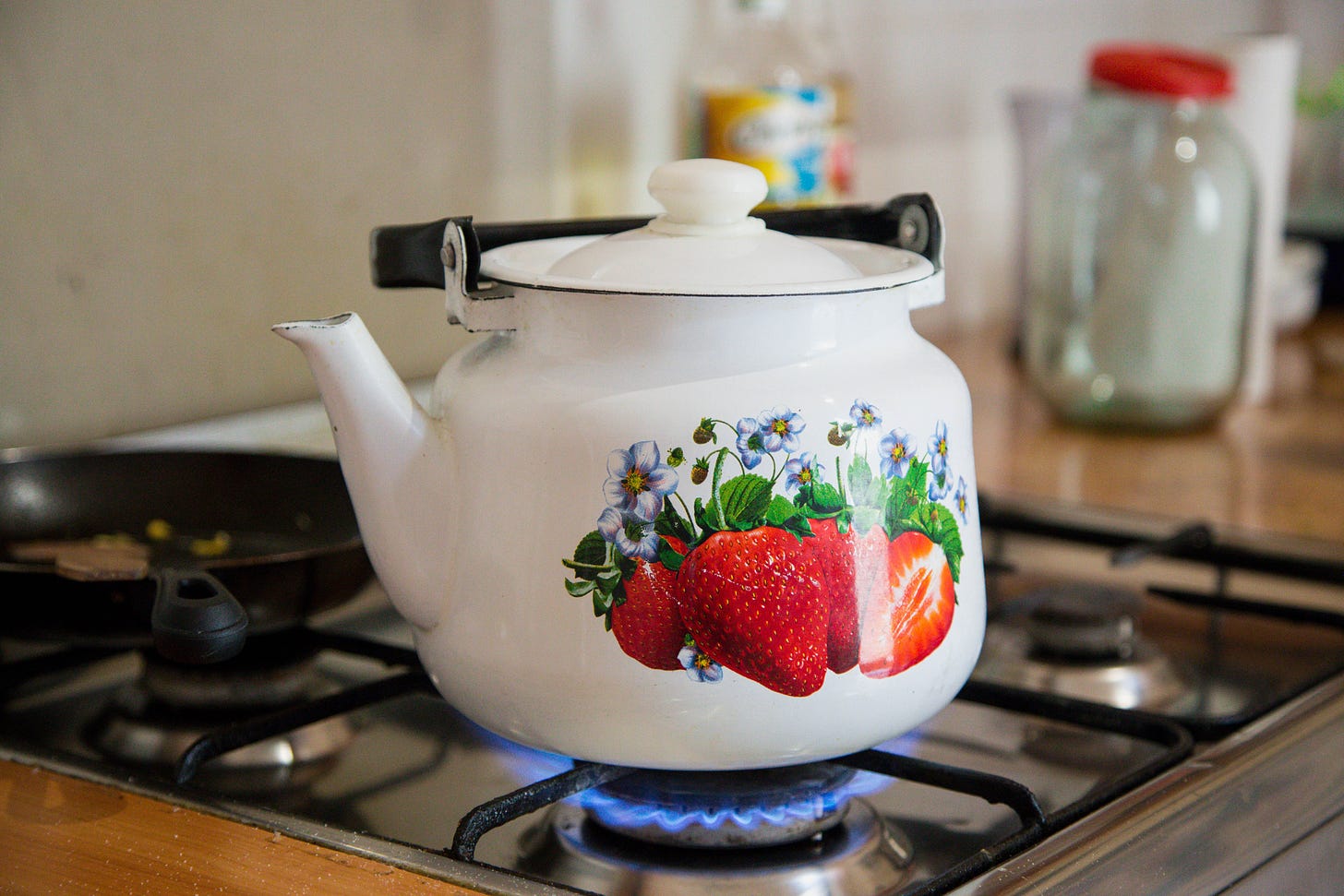Tea kettle on a stove top by Ioann-Mark Kuznietsov