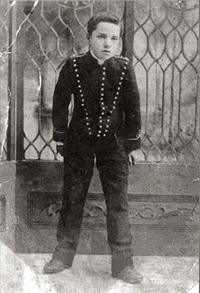 A child in a uniform

Description automatically generated