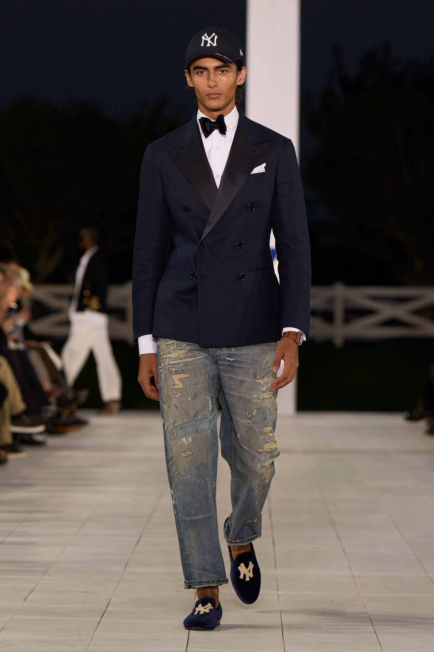 Image may contain Clothing Pants Blazer Coat Jacket Formal Wear Suit Jeans Adult Person Footwear and Shoe