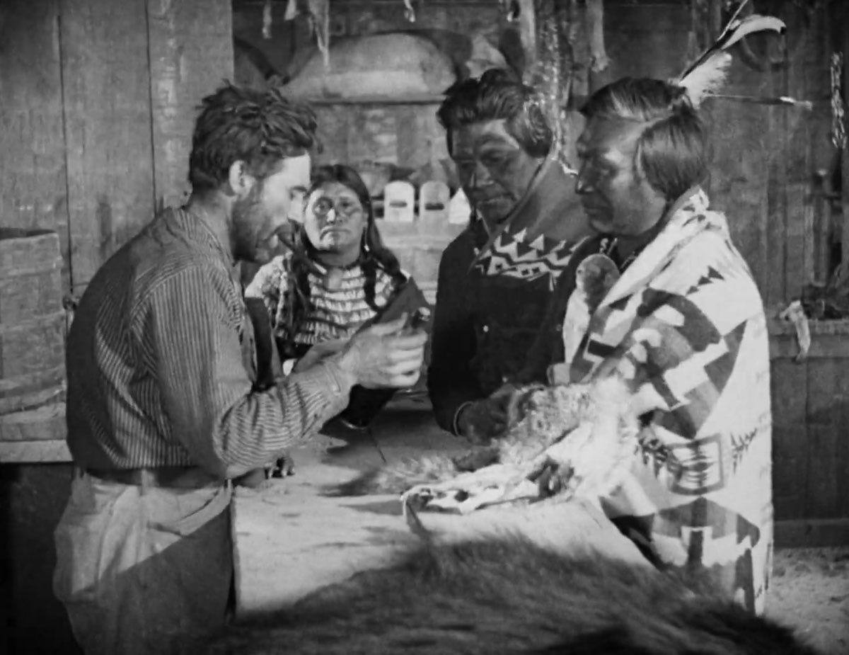 Three native American characters buying whiskey at a trading post in the 1923 film The Covered Wagon
