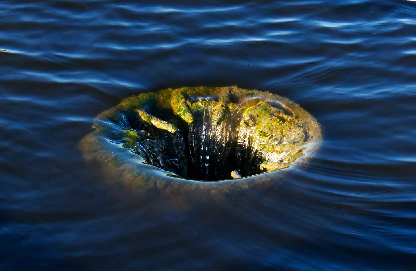 a mysterious hole in the water, into which the water is plunging