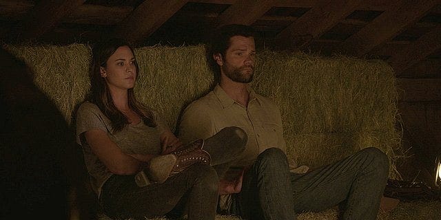 Walker Cordell sitting with Geri on bales of hay 1.14.