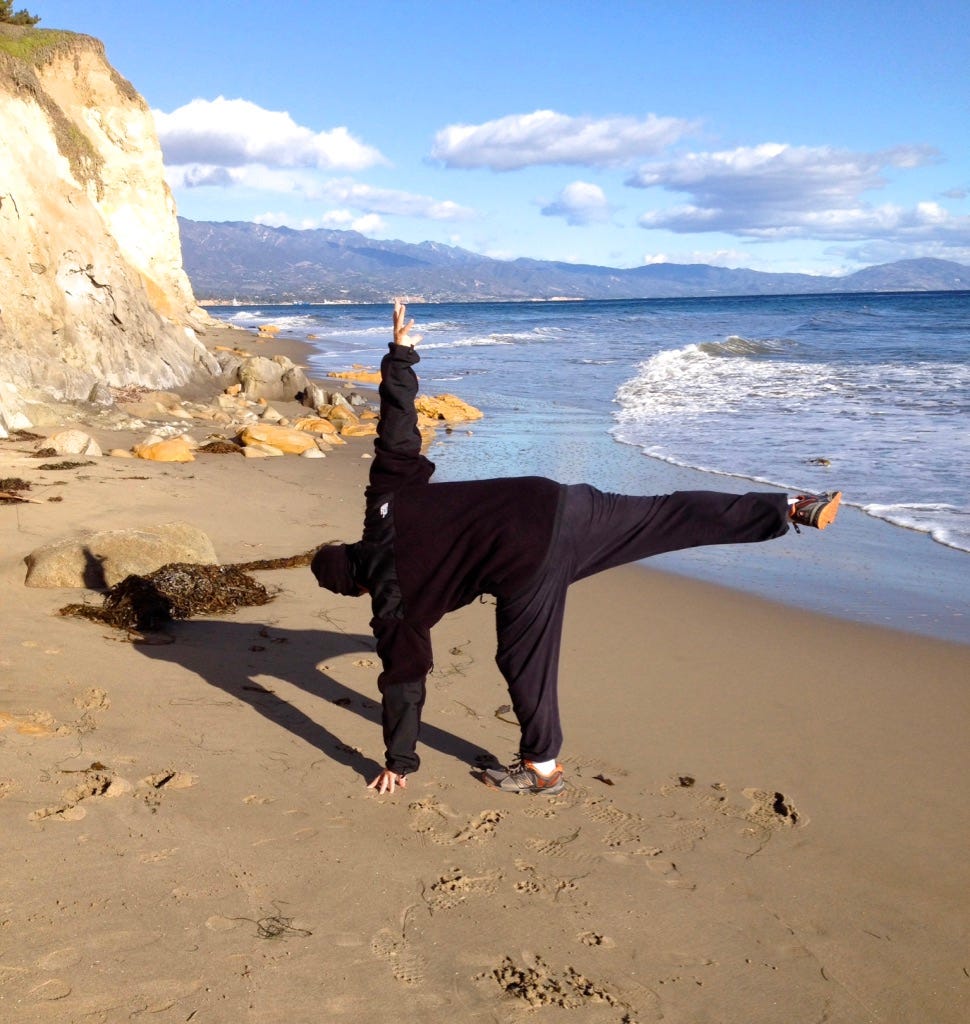 Picture of a yoga pose on a beach.