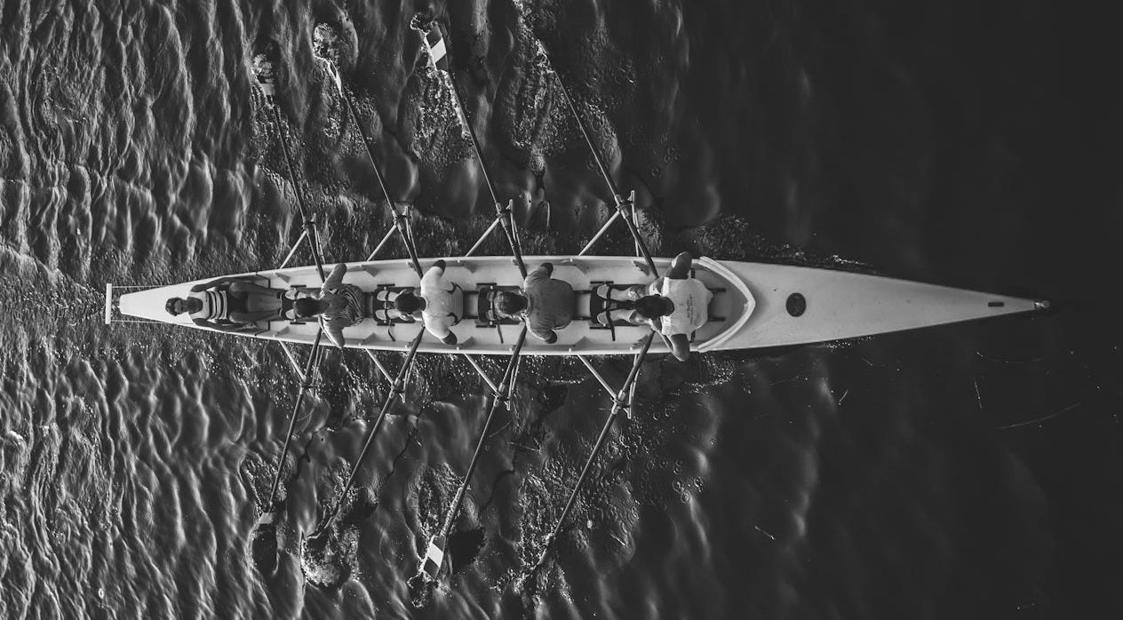 people riding boat on body of water