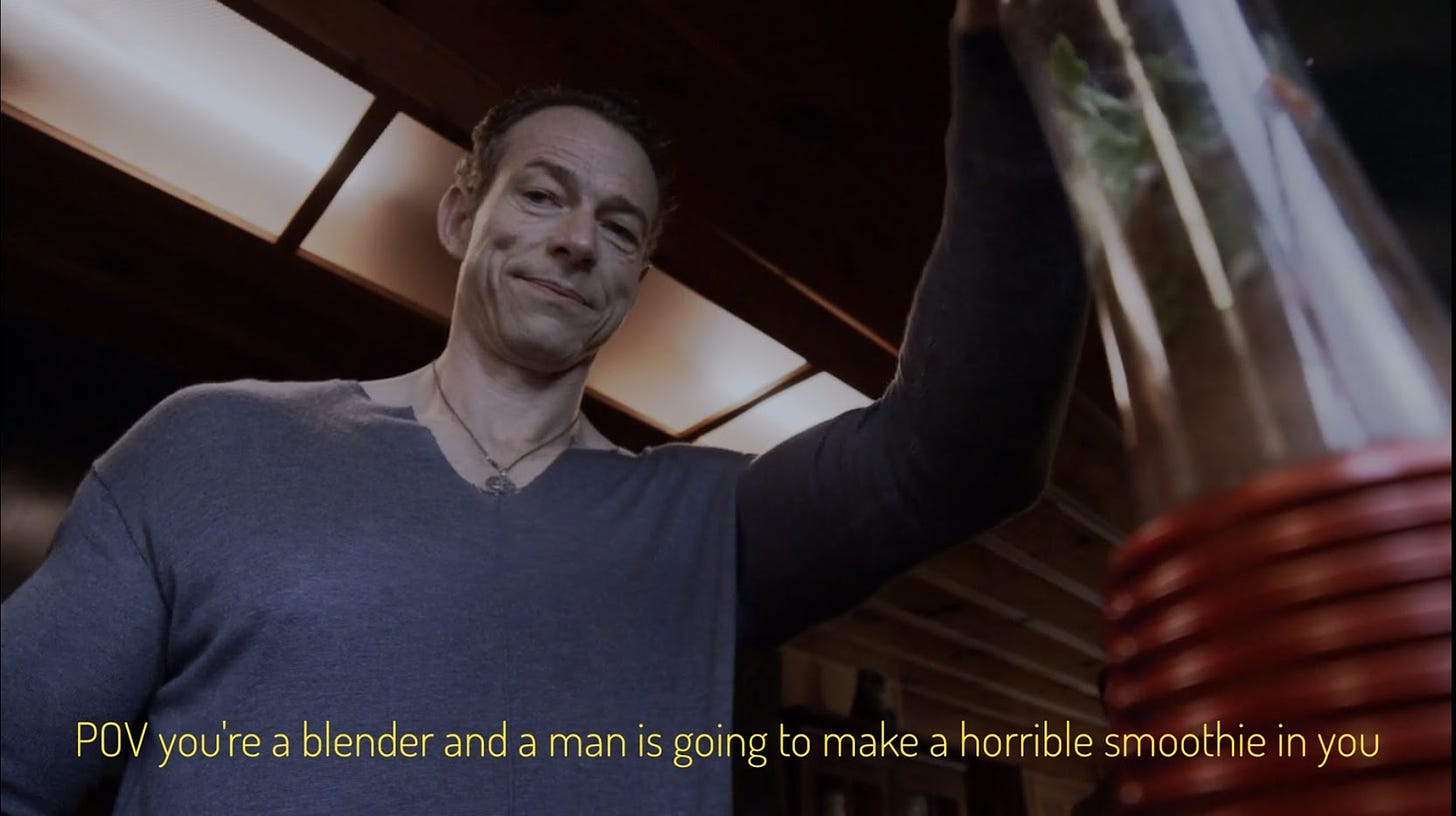 A blender's eye view of Desmond, a middle-aged white man with receding hairline and necklace, captioned "POV you're a blender and a man is going to make a horrible smoothie in you"