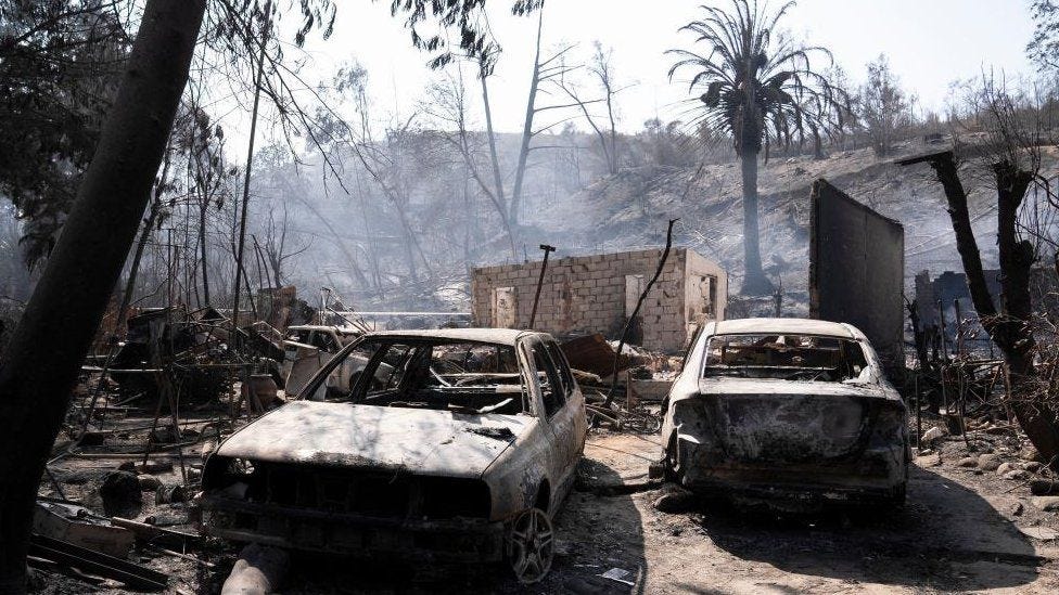Burned cars stand outside the devastated home of Patricia Araya, known as 'La Pati,' a staff at the Botanical Garden of Vina del Mar who died in a fire along with her mother and her two grandchildren, aged 9 and one, in Vina del Mar, Chile, 05 February 2024