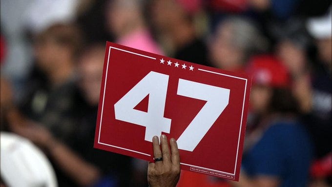 A supporter holds a sign as Republican presidential nominee former President Donald Trump speaks at a campaign rally at the Resch Center, Wednesday, Oct. 30, 2024, in Green Bay, Wis. (AP Photo/Alex Brandon)