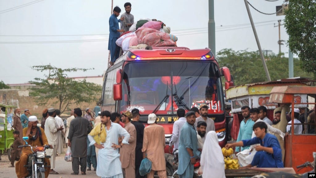 FILE - Afghan refugees board a bus from Karachi, Pakistan, to Afghanistan on Sept. 21, 2023. Afghans have poured into Pakistan by the millions during decades of wars. Pakistan on Oct. 3 ordered undocumented immigrants to leave the country by Nov. 1.