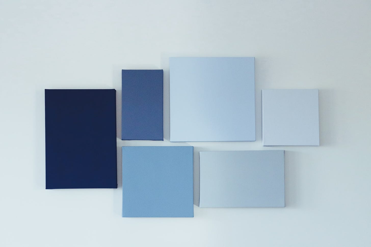 A collection of blank canvases in various shades of blue.