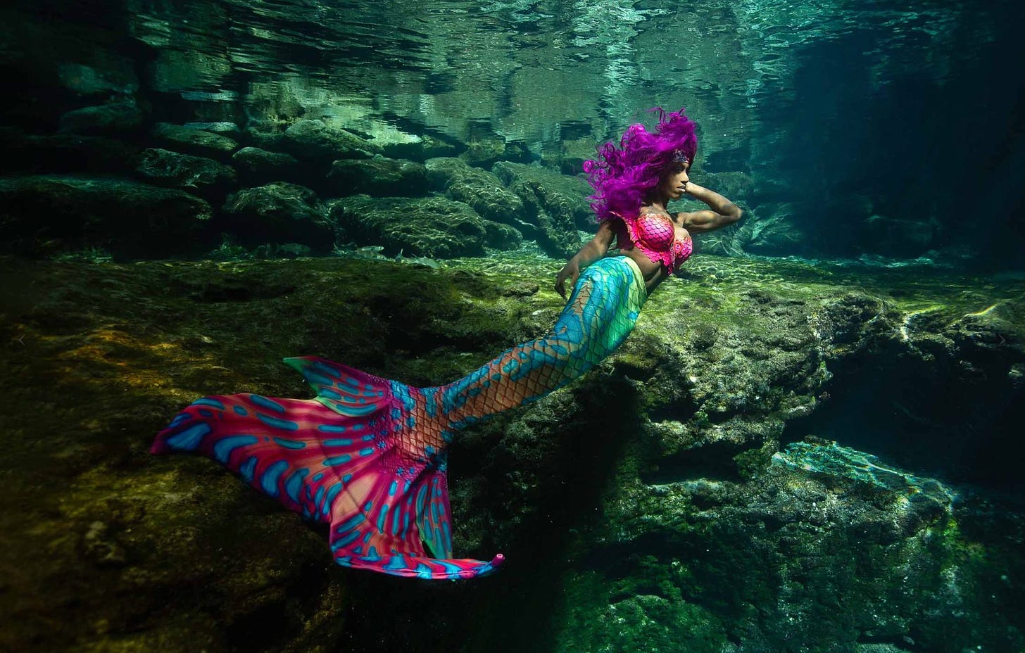A person dressed as a mermaid underwater with full tail!